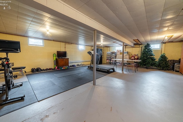 workout room featuring concrete block wall