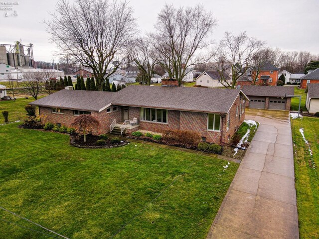 ranch-style home with a residential view, crawl space, brick siding, and a front yard