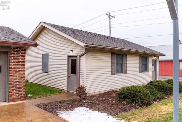 exterior space featuring a shingled roof