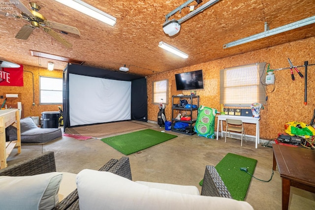 recreation room featuring golf simulator and concrete floors