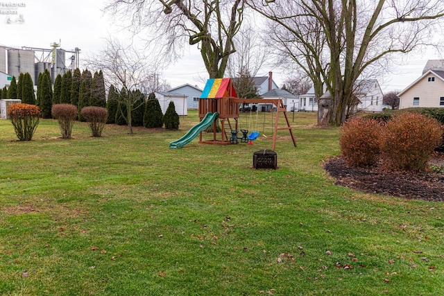 view of playground with a lawn