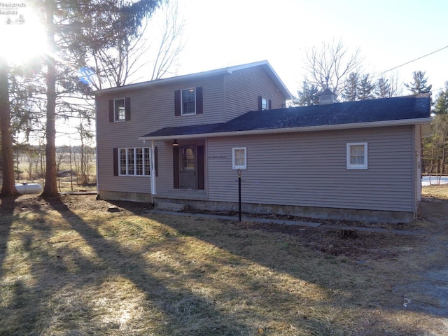 rear view of property with a chimney