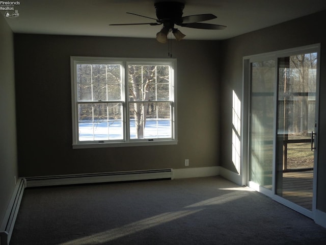 carpeted spare room featuring a baseboard heating unit, a ceiling fan, and baseboards