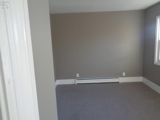 unfurnished room featuring a baseboard radiator, carpet flooring, and baseboards