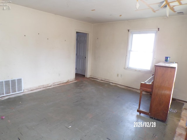 unfurnished room with visible vents