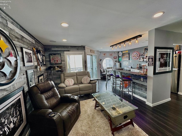 living room with recessed lighting, a large fireplace, wood finished floors, baseboards, and track lighting