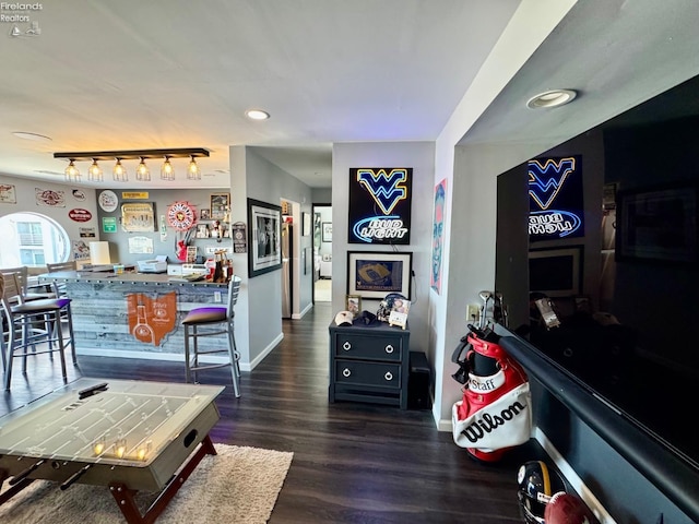 interior space featuring track lighting, recessed lighting, wood finished floors, and baseboards