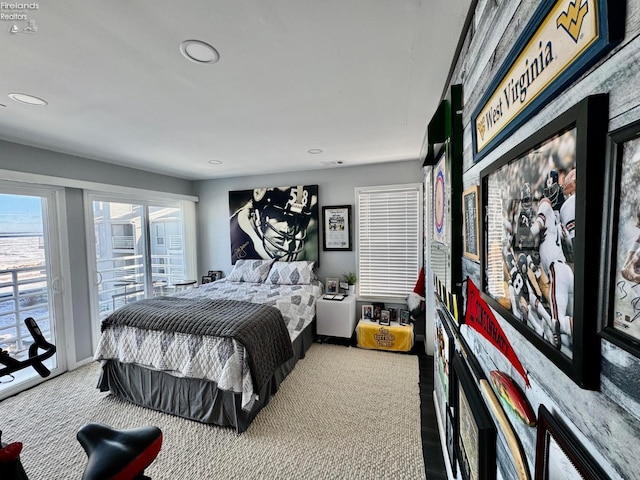 bedroom featuring access to outside, baseboards, and recessed lighting