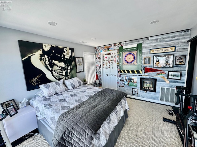 carpeted bedroom featuring visible vents