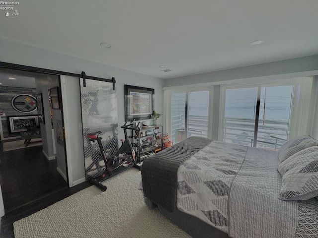 bedroom with a barn door and visible vents