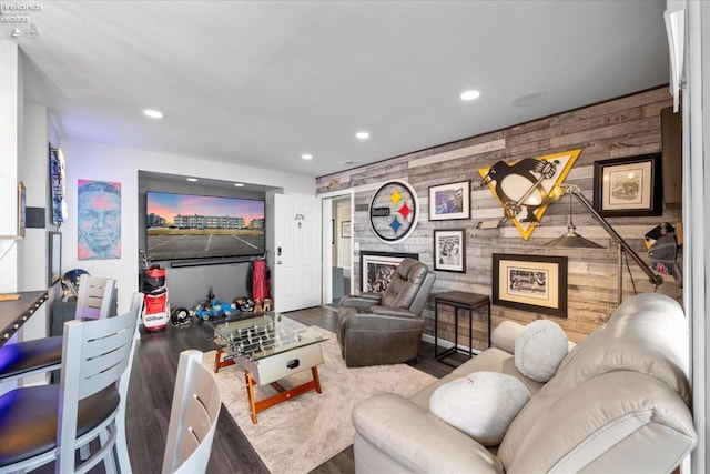 living room with wooden walls, a fireplace, and recessed lighting