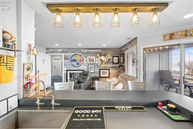 interior space featuring dark countertops, recessed lighting, a large fireplace, open floor plan, and a sink