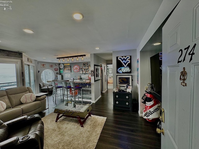 living room featuring dark wood-style floors, recessed lighting, rail lighting, and baseboards