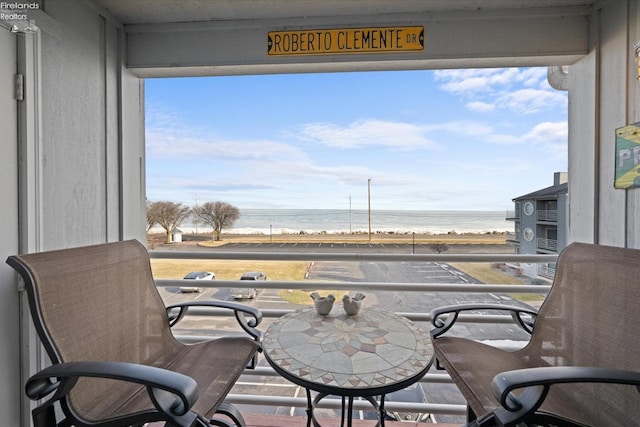 balcony with a view of the beach and a water view