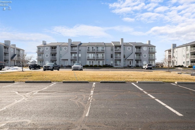 view of building exterior with uncovered parking