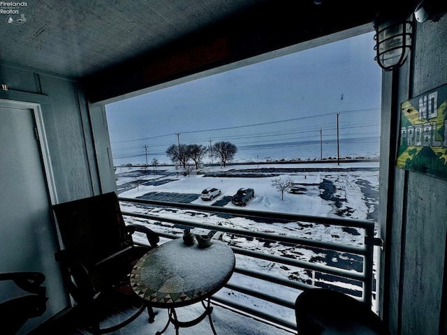 view of snow covered back of property