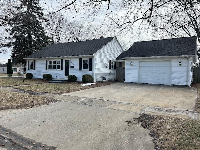 ranch-style house with an attached garage, a chimney, concrete driveway, and roof with shingles