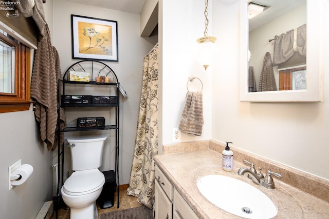 bathroom featuring vanity, toilet, and a textured ceiling