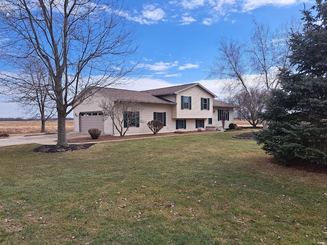 tri-level home featuring a garage, a front yard, and concrete driveway