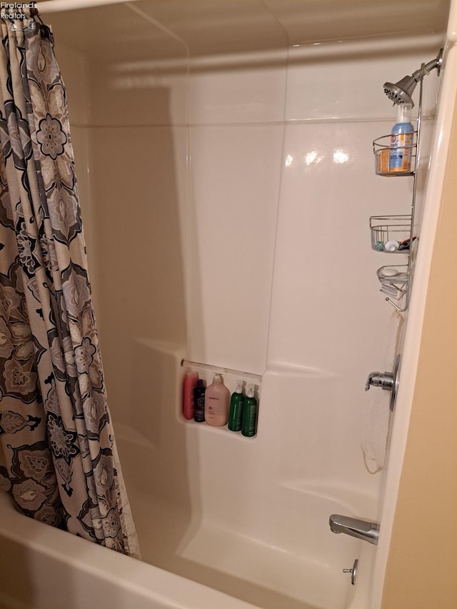 bathroom with shower / bath combination with curtain