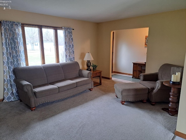 living room featuring baseboards and carpet flooring