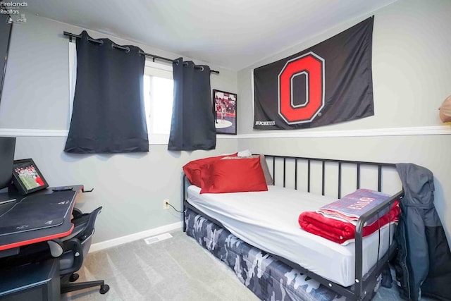 bedroom featuring baseboards and carpet flooring