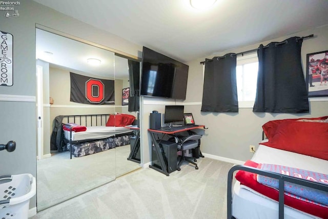 bedroom with carpet, baseboards, and a closet