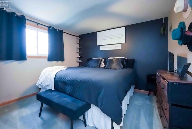 carpeted bedroom featuring baseboards