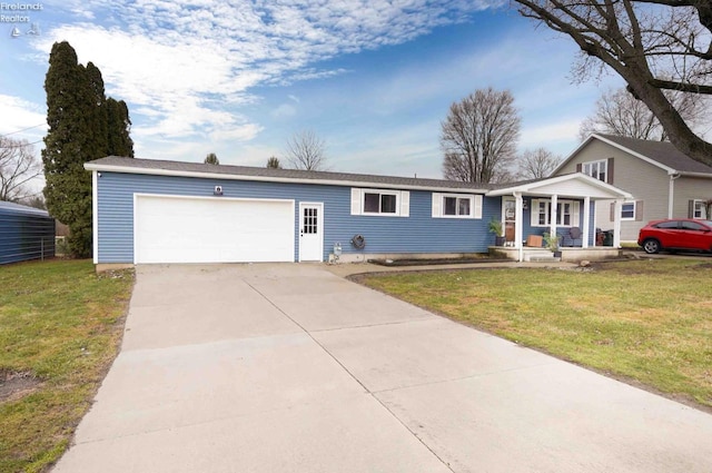 ranch-style home featuring a porch, an attached garage, concrete driveway, and a front lawn