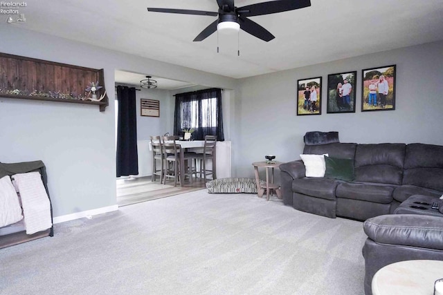 living room with baseboards, carpet floors, and ceiling fan