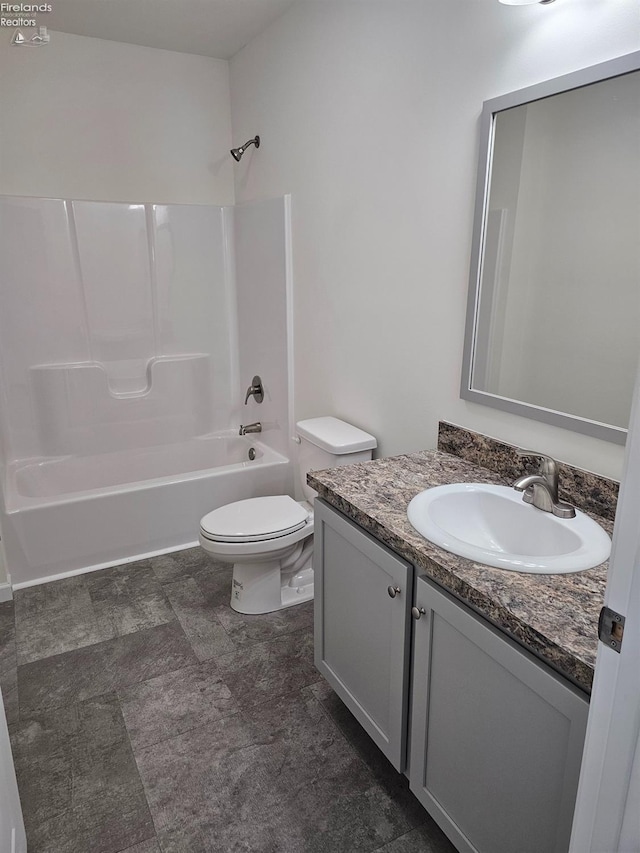 bathroom featuring tub / shower combination, vanity, and toilet