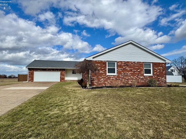 ranch-style home with a garage, a front yard, concrete driveway, and brick siding