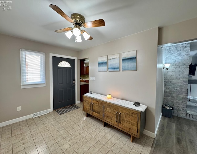 entryway with ceiling fan, visible vents, and baseboards