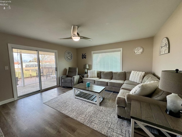 living area with ceiling fan, wood finished floors, and baseboards