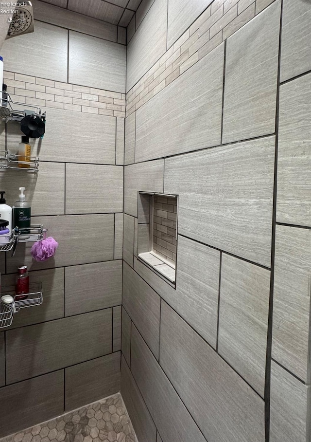 bathroom with a tile shower