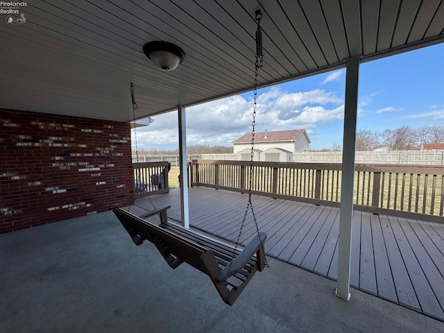 wooden terrace featuring fence