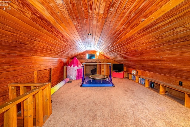 interior space featuring wood ceiling, wooden walls, vaulted ceiling, and carpet flooring