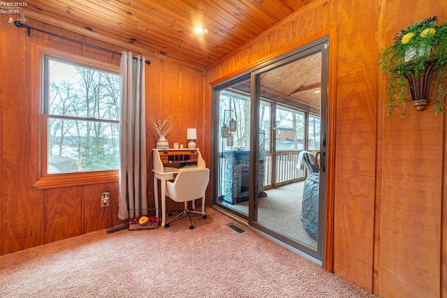 office space featuring visible vents, wood walls, carpet, and wood ceiling