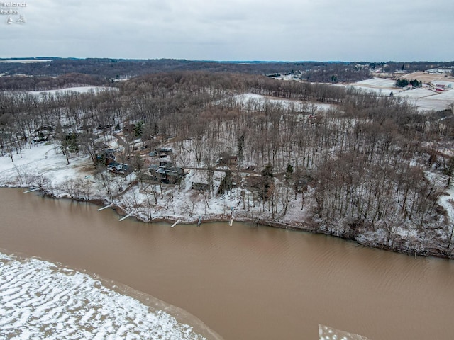 snowy aerial view featuring a water view