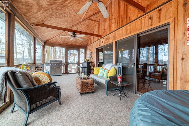 sunroom / solarium with vaulted ceiling, ceiling fan, and wooden ceiling