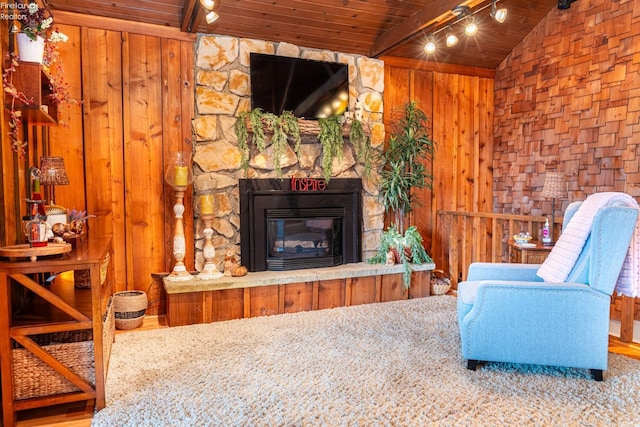 living area featuring wooden ceiling, a fireplace, track lighting, and beam ceiling