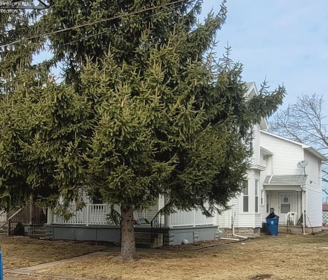 view of side of home with covered porch