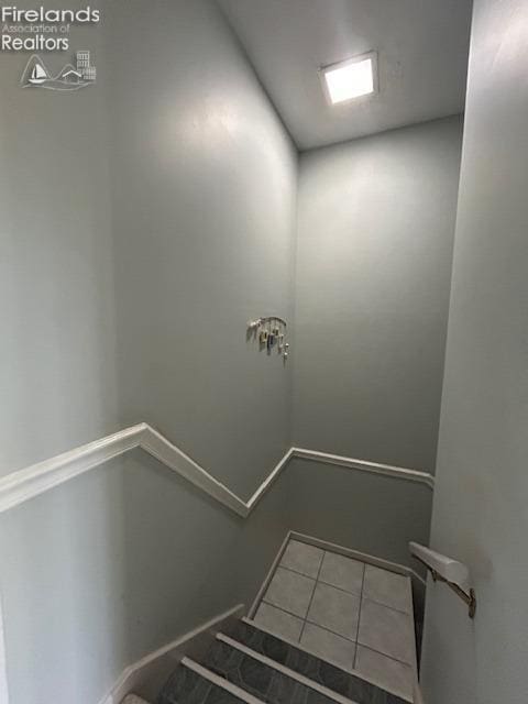 stairway featuring tile patterned floors