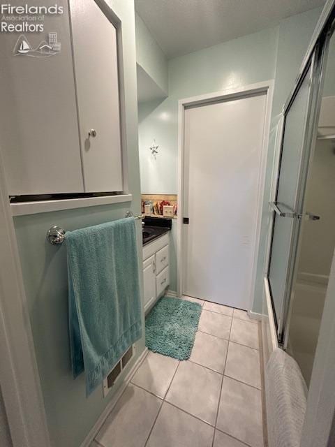 full bath featuring vanity and tile patterned floors