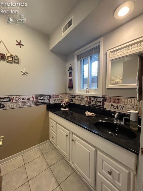 bathroom featuring tile patterned flooring, visible vents, and vanity