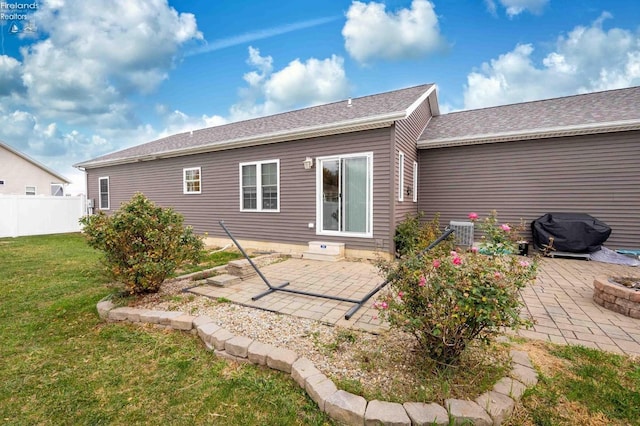 back of house featuring a yard, a patio, fence, and central AC unit