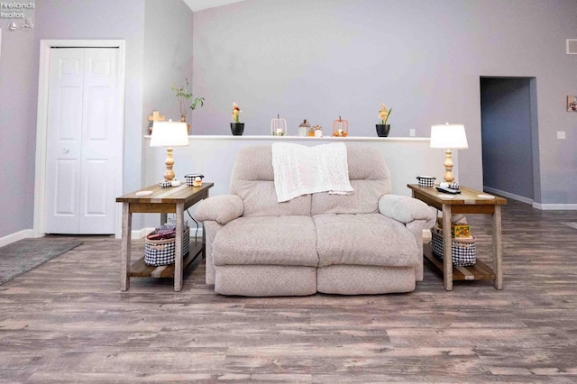 living area featuring wood finished floors, visible vents, and baseboards