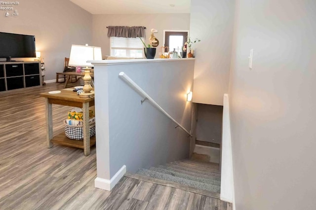 stairs featuring baseboards and wood finished floors