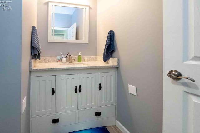 bathroom featuring vanity and baseboards