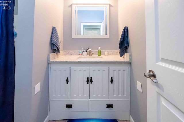 bathroom featuring vanity and baseboards